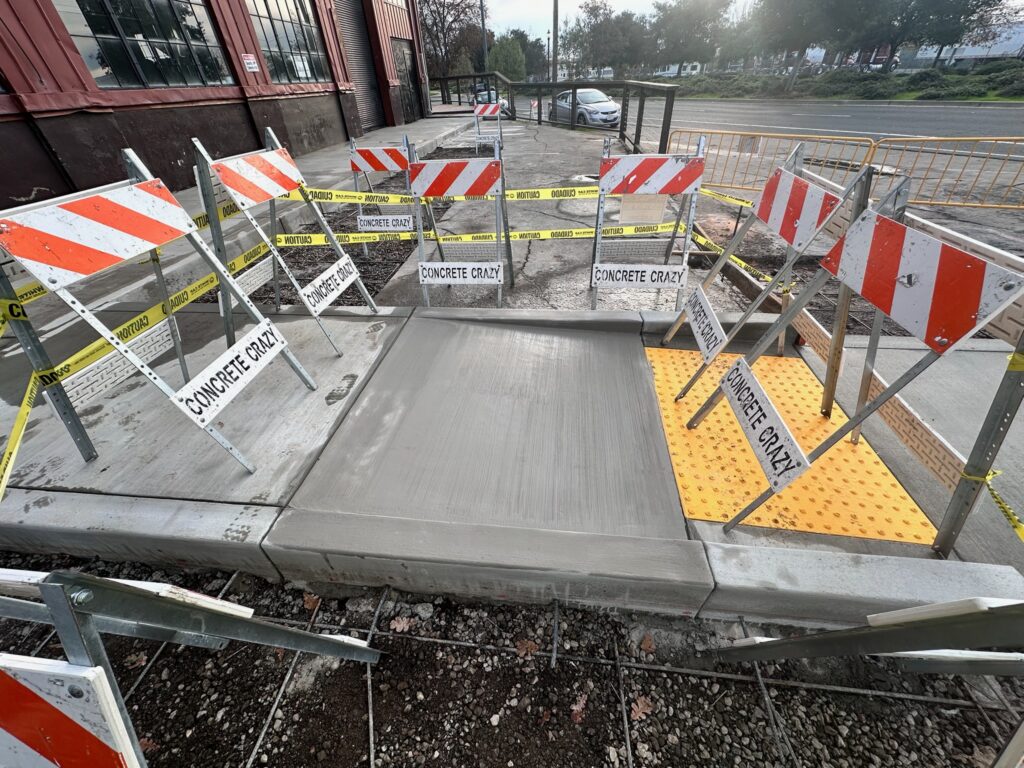Newly finished ADA-compliant curb ramp with truncated dome, Bay Area