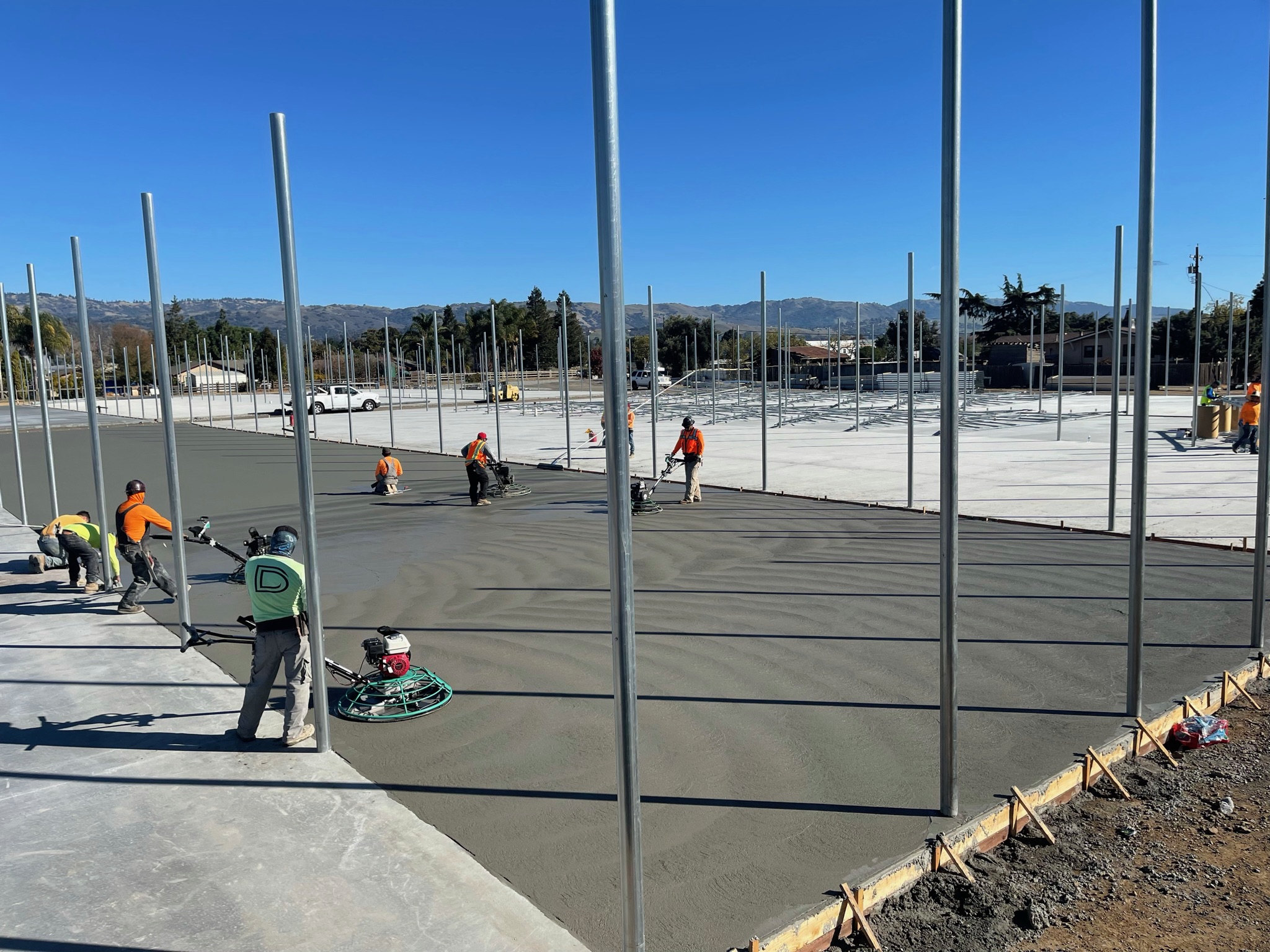 Crew power troweling a large commercial concrete slab, South Bay Area