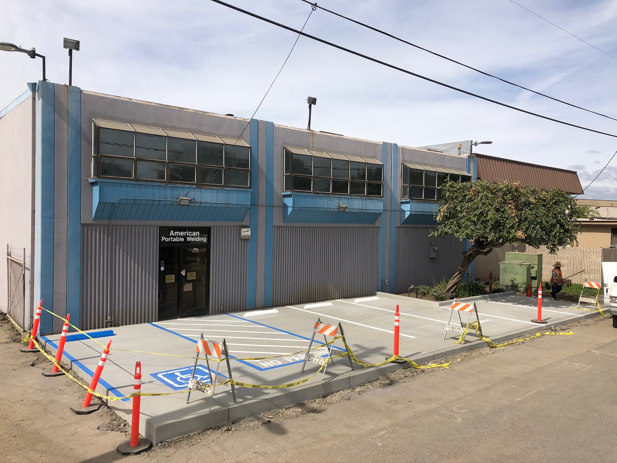 ADA-compliant accessible parking space in a new commercial concrete lot, South Bay Area